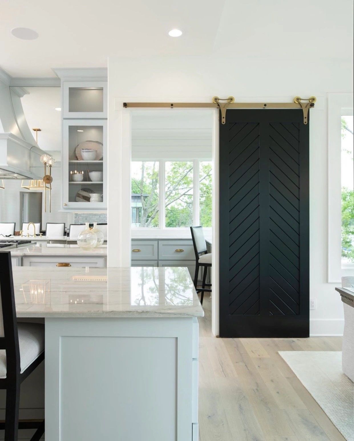 Blue laundry room with brass hardware and marble countertop