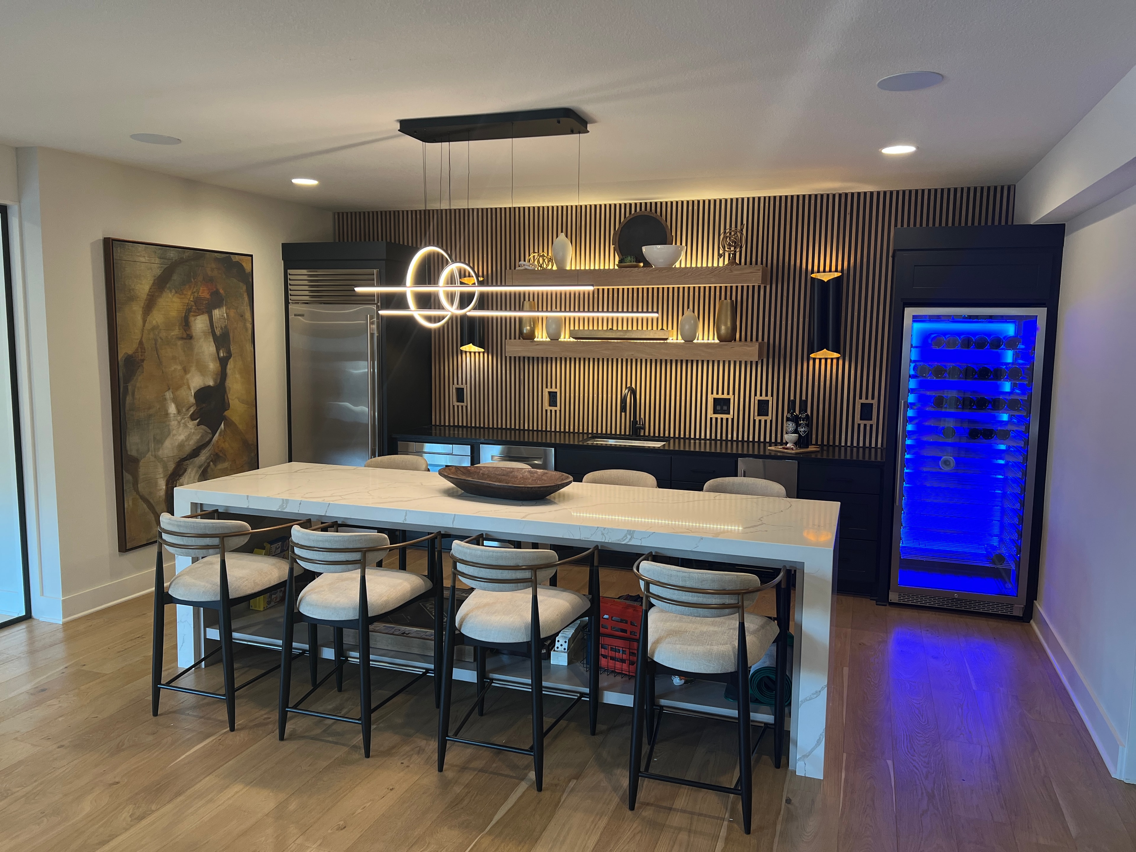 Elegant kitchen bar with marble island and wine fridge